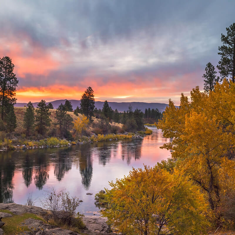 A beautiful orange and purple sunset over the Spokane river.