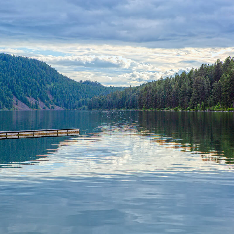 A peaceful lake with overcast skies.
