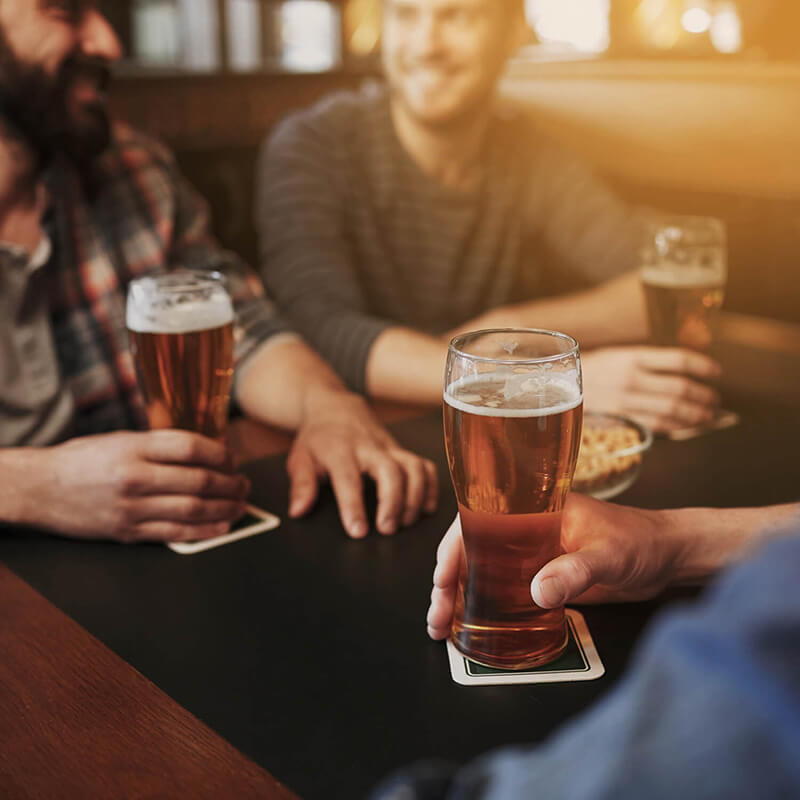 Three friends grabbing drinks at a brewing company.