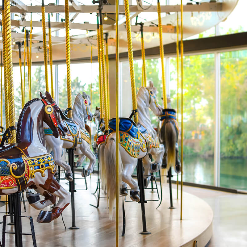 Inanimate painted horses on a carousel.