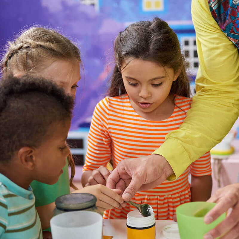 Kids playing with science materials.