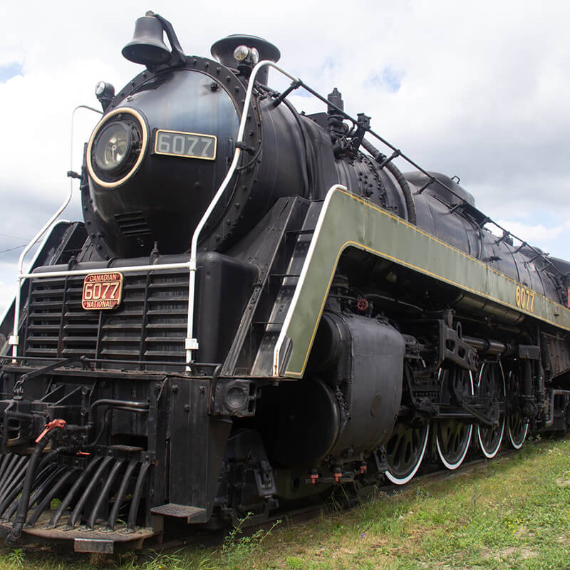 A locomotive train on display at an outdoor museum.