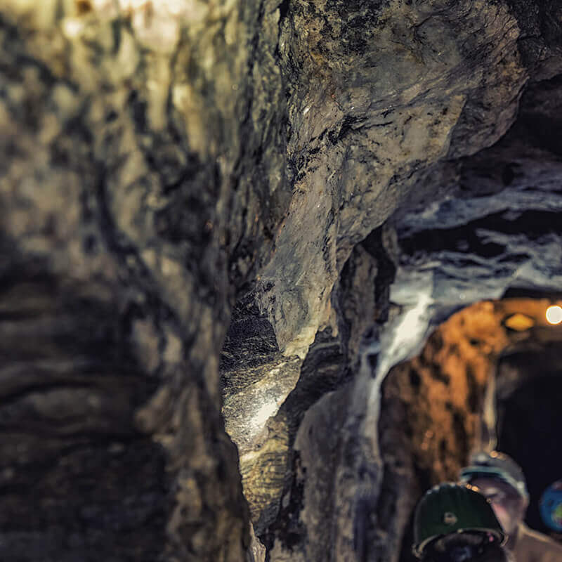 A closeup view of the walls on the inside of a mine shaft.