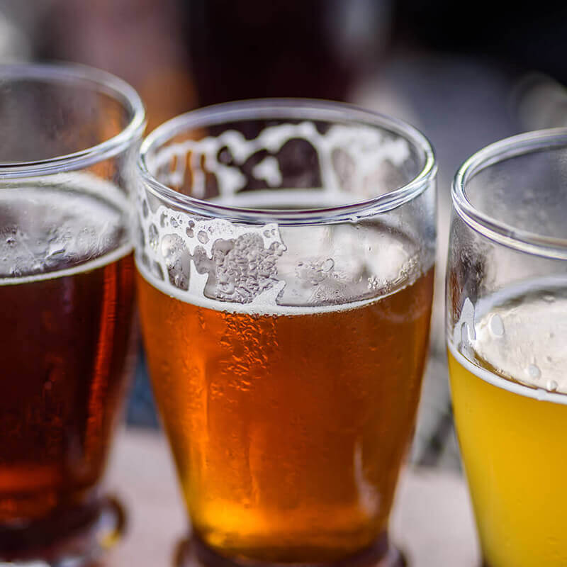Three beer glasses next to each for tasting.