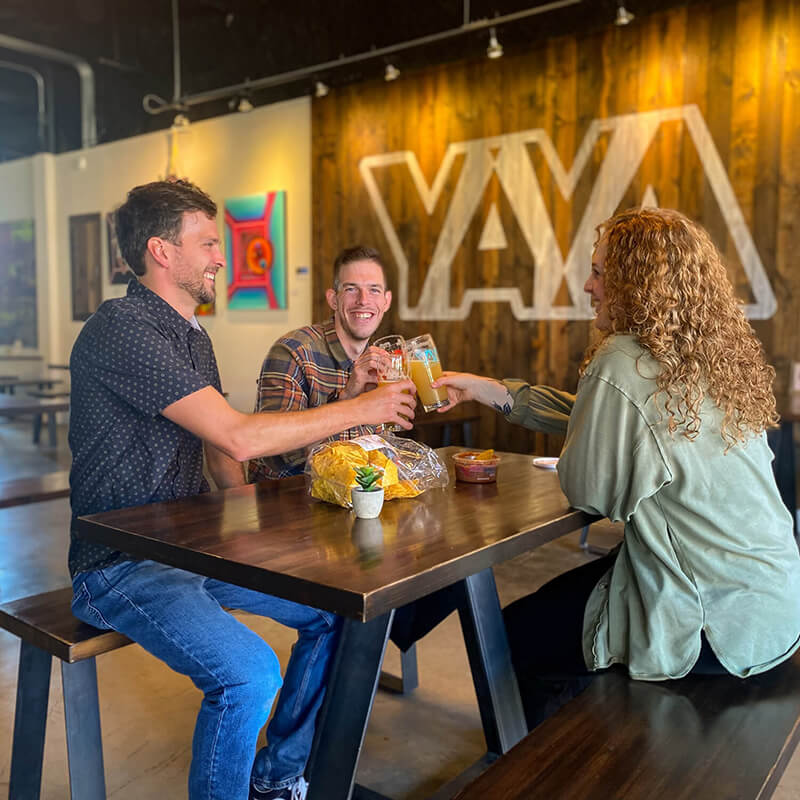 A group of friends toasting beer glasses.